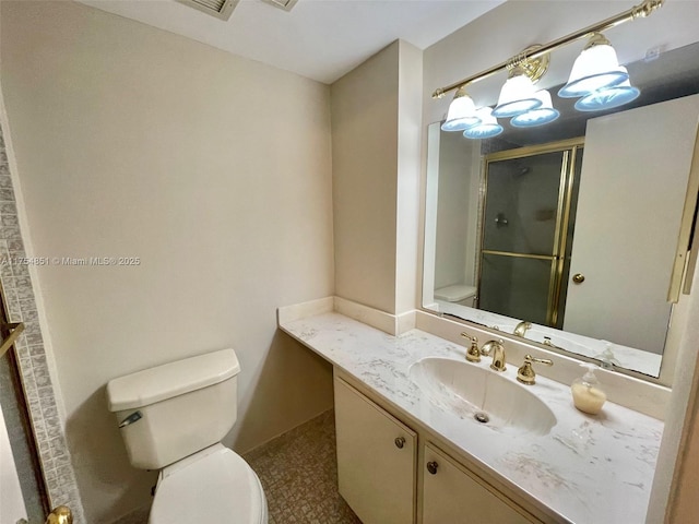 full bathroom with a shower stall, toilet, and vanity