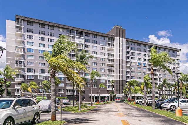 view of building exterior featuring uncovered parking