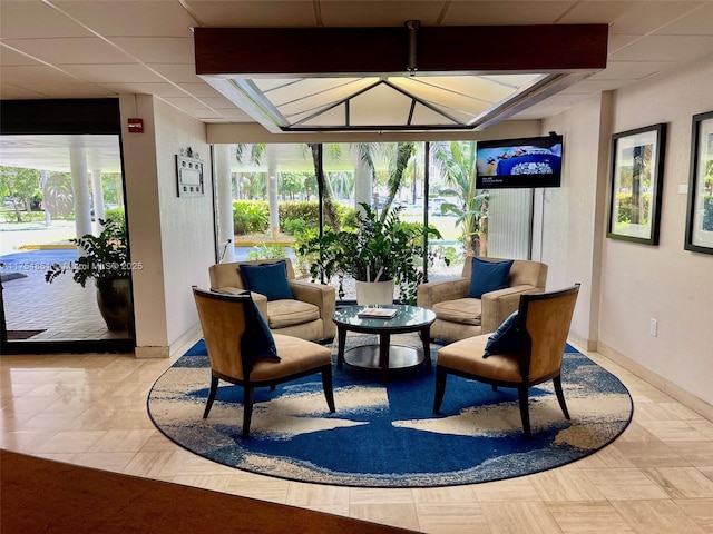 sunroom featuring a paneled ceiling