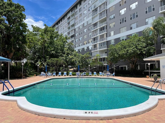 view of swimming pool featuring a patio