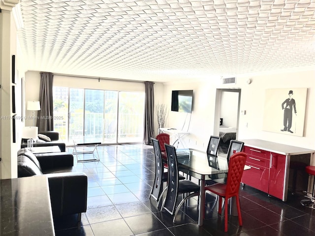 tiled dining space featuring visible vents