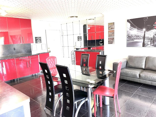 dining space featuring dark tile patterned flooring