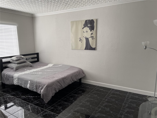 bedroom with ornamental molding, a textured wall, and baseboards