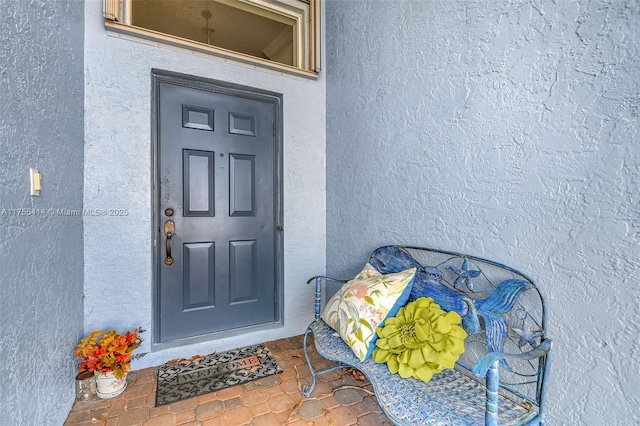 doorway to property with stucco siding