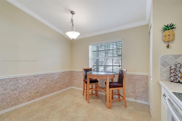 dining room featuring ornamental molding, wainscoting, wallpapered walls, and light tile patterned flooring