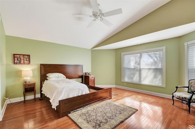 bedroom featuring lofted ceiling, light wood-style floors, ceiling fan, and baseboards