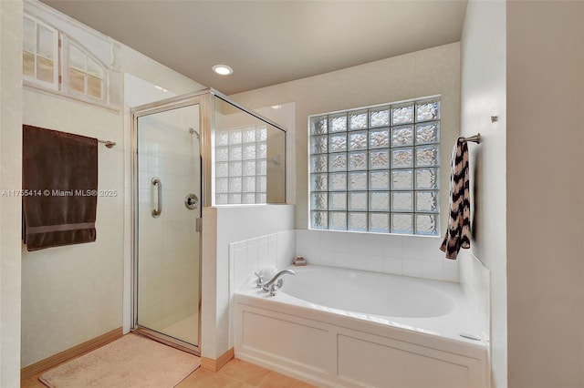 full bath with a garden tub, a shower stall, and tile patterned flooring
