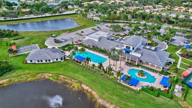 drone / aerial view featuring a residential view and a water view