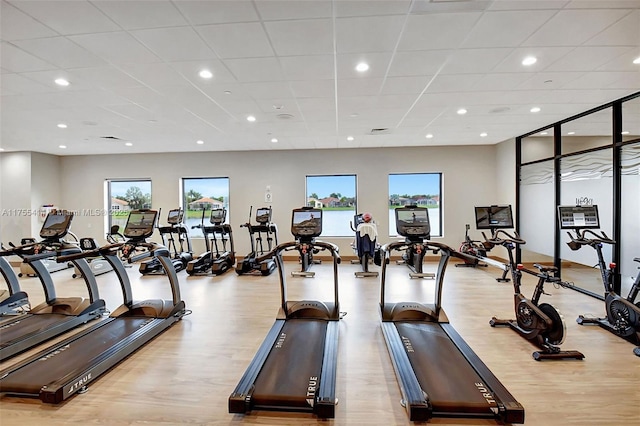 workout area featuring wood finished floors, a paneled ceiling, and recessed lighting