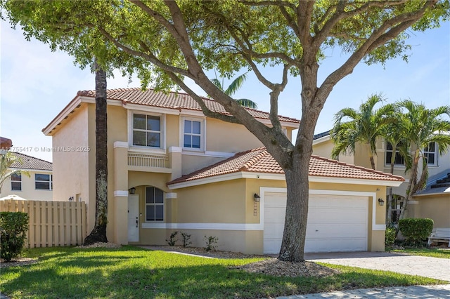 mediterranean / spanish house with a garage, fence, driveway, stucco siding, and a front yard