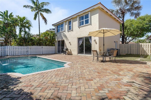 view of pool with a patio, grilling area, a fenced backyard, and a fenced in pool