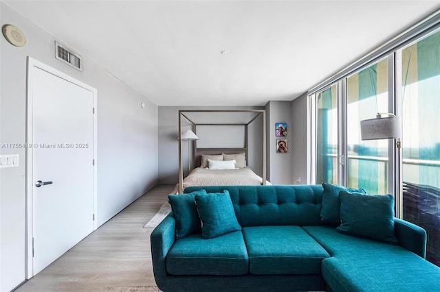 bedroom with visible vents and light wood-style flooring