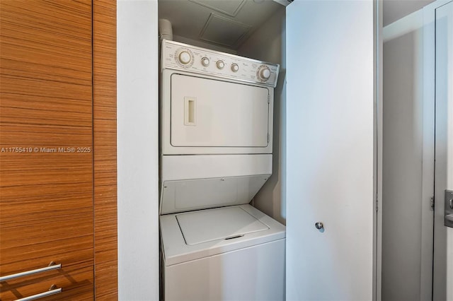 laundry area with stacked washing maching and dryer and laundry area