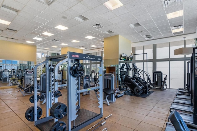 gym with a paneled ceiling and visible vents