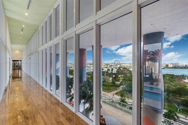 corridor featuring a water view and wood finished floors