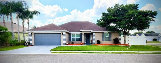 ranch-style home featuring stucco siding, driveway, a front yard, a garage, and fence