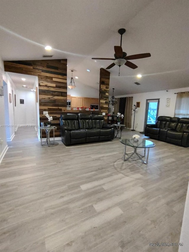 living area featuring light wood-type flooring, visible vents, ceiling fan, and lofted ceiling