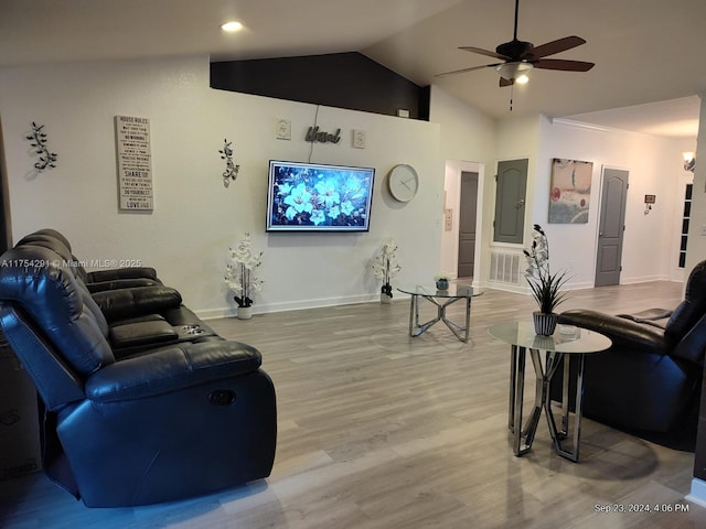 living area featuring baseboards, light wood-style floors, visible vents, lofted ceiling, and ceiling fan