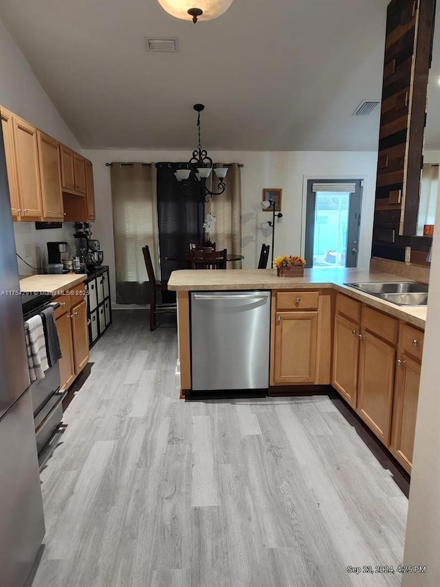 kitchen with light wood-style floors, stainless steel dishwasher, a peninsula, a sink, and a notable chandelier