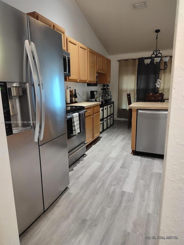 kitchen with light wood-type flooring, visible vents, vaulted ceiling, appliances with stainless steel finishes, and a notable chandelier