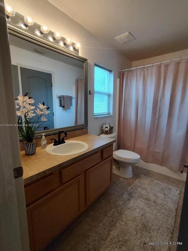 bathroom featuring toilet, tile patterned floors, and vanity