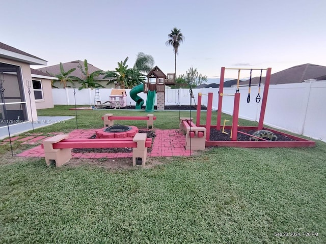 community play area featuring a yard and a fenced backyard