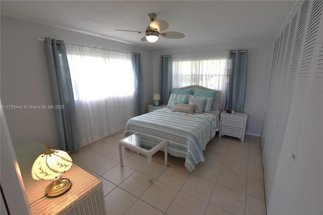 bedroom with a ceiling fan and light tile patterned floors