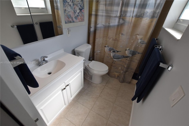 full bath featuring toilet, tiled shower, tile patterned flooring, and vanity