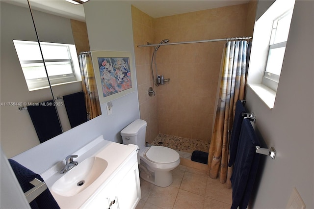 full bath with vanity, tiled shower, tile patterned flooring, and toilet