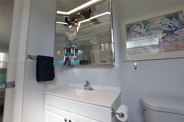 bathroom with toilet and vanity