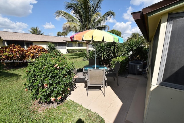 view of patio with outdoor dining area and central AC