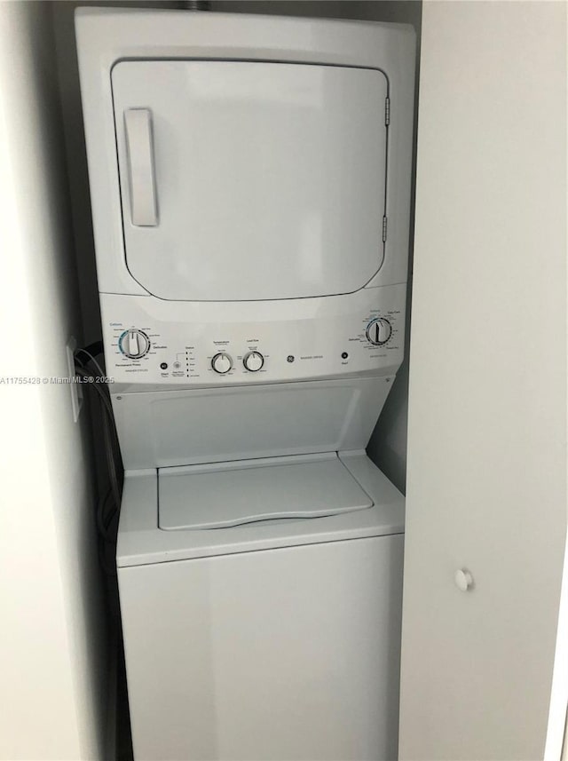 laundry room featuring laundry area and stacked washer and clothes dryer