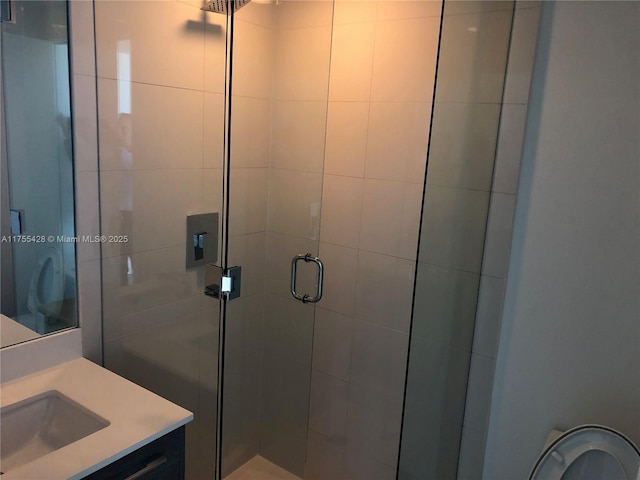 full bath with a stall shower and vanity