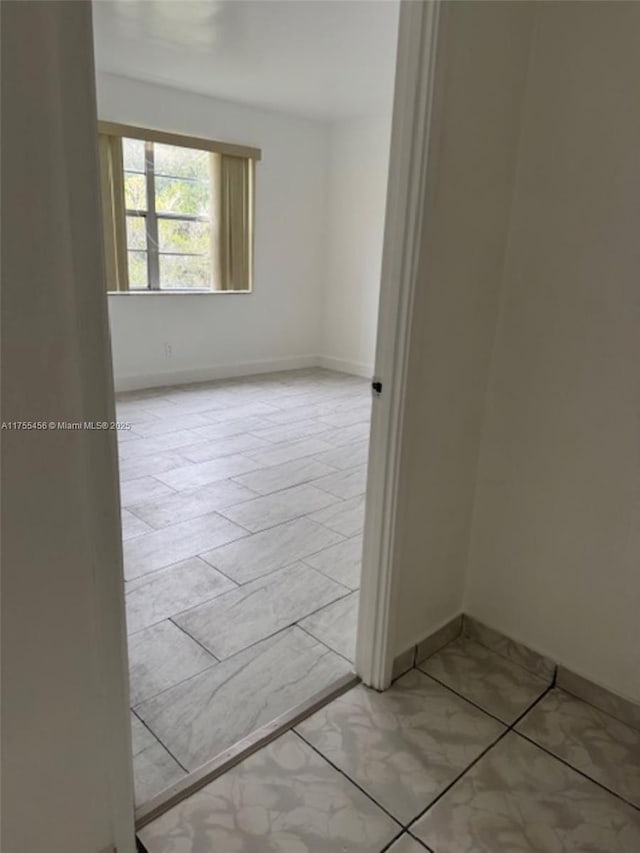 empty room with baseboards