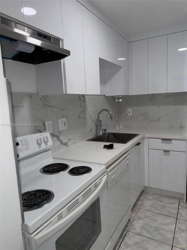 kitchen with under cabinet range hood, white appliances, a sink, white cabinetry, and modern cabinets