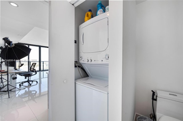 laundry room with stacked washer and clothes dryer and laundry area