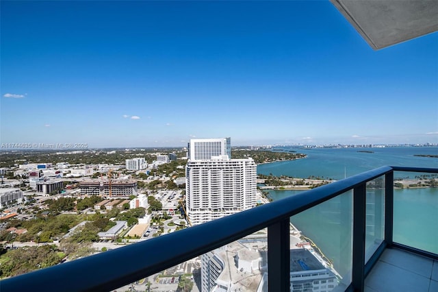 balcony featuring a water view and a city view