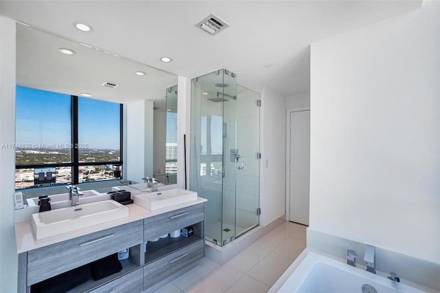 bathroom featuring a stall shower, visible vents, and a sink