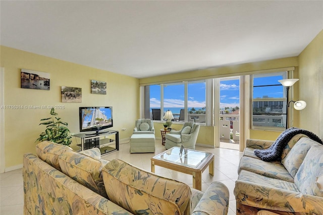 3111 N Ocean Dr Unit 508, Hollywood, FL 33019 - living area with light tile patterned flooring, plenty of natural light, and baseboards