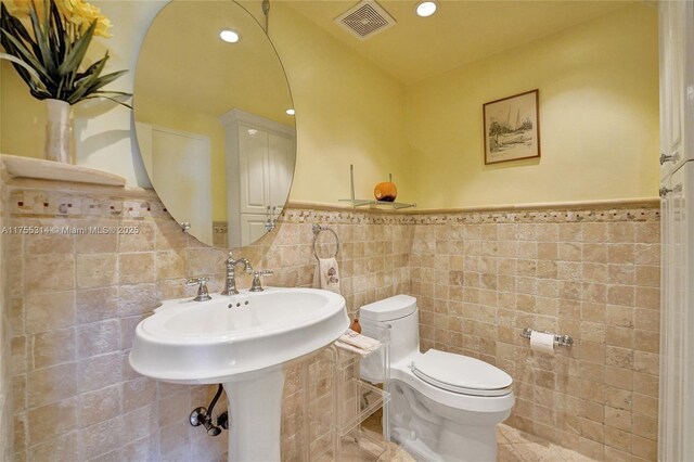 3111 N Ocean Dr Unit 508, Hollywood, FL 33019 - bathroom with tile walls, toilet, a wainscoted wall, and recessed lighting