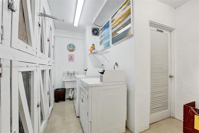 3111 N Ocean Dr Unit 508, Hollywood, FL 33019 - washroom with light tile patterned floors, washing machine and clothes dryer, and cabinet space