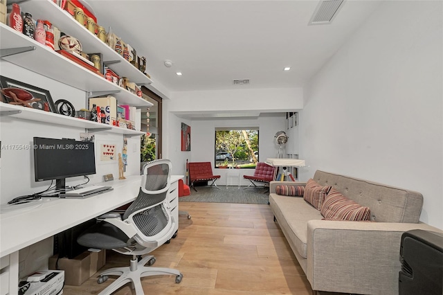 office space featuring recessed lighting, visible vents, and light wood finished floors