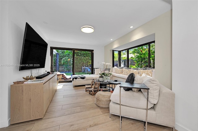 living area featuring recessed lighting and light wood-style flooring