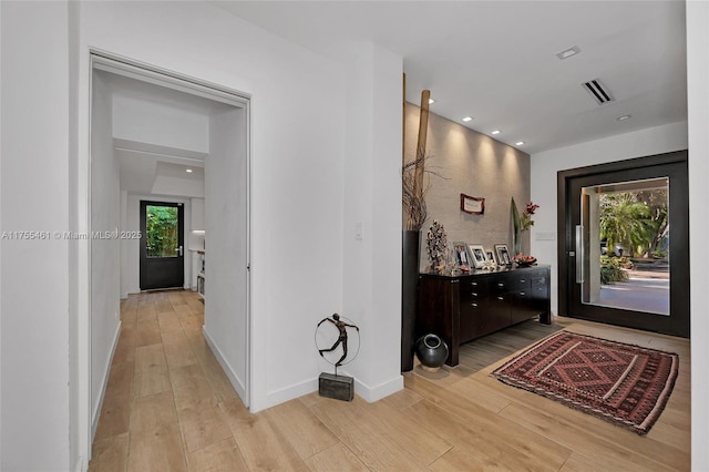 hall with recessed lighting, baseboards, visible vents, and light wood finished floors