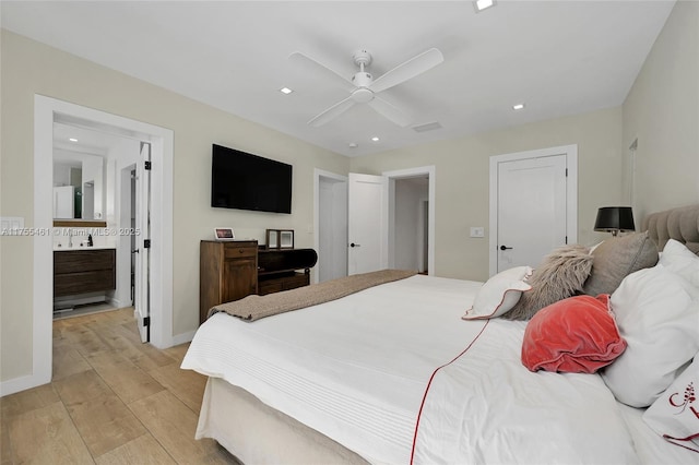 bedroom with light wood finished floors, recessed lighting, ensuite bathroom, a ceiling fan, and baseboards