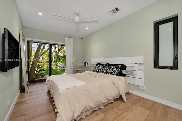 bedroom featuring a ceiling fan, wood finished floors, visible vents, and baseboards