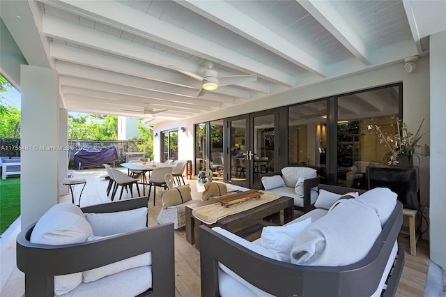 view of patio / terrace with outdoor dining area, outdoor lounge area, and a ceiling fan