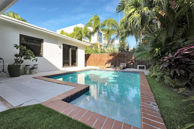 view of swimming pool with a fenced in pool, a patio area, and fence