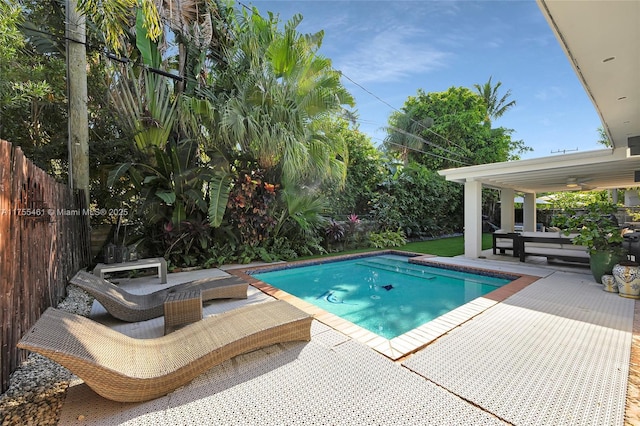 view of pool featuring a patio area, fence, and a fenced in pool