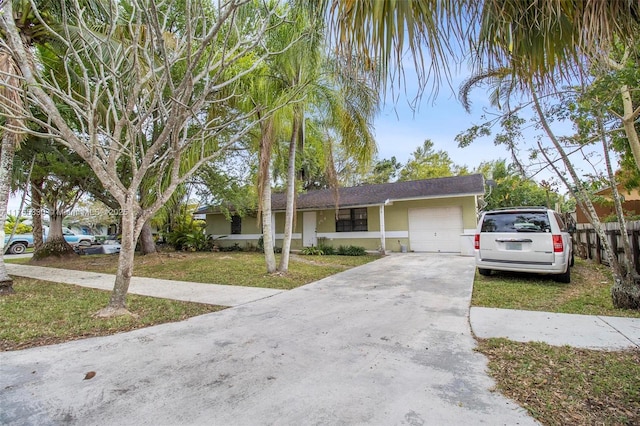 single story home featuring a garage, stucco siding, concrete driveway, and a front yard